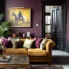 Moody, elegant living room with plum walls, a mustard velvet sofa accented with plum and neutral cushions, a wooden coffee table, and a plum floral-patterned rug— styled with a horse painting, indoor plant, and dark double doors.​