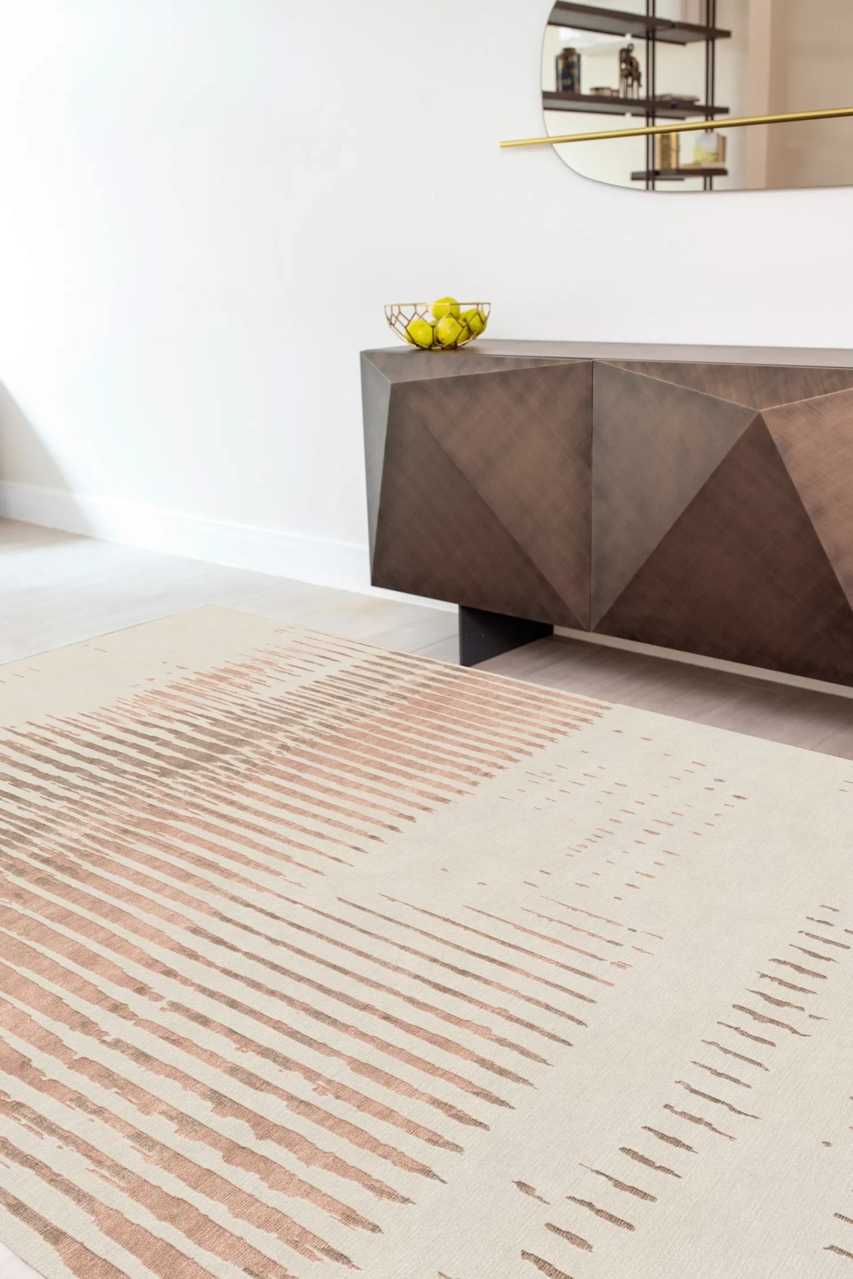 Luxury hand-knotted rug in ivory and warm terracotta tones with abstract linear pattern, styled in a contemporary interior with geometric metallic sideboard, showcasing Northwest 35 craftsmanship.