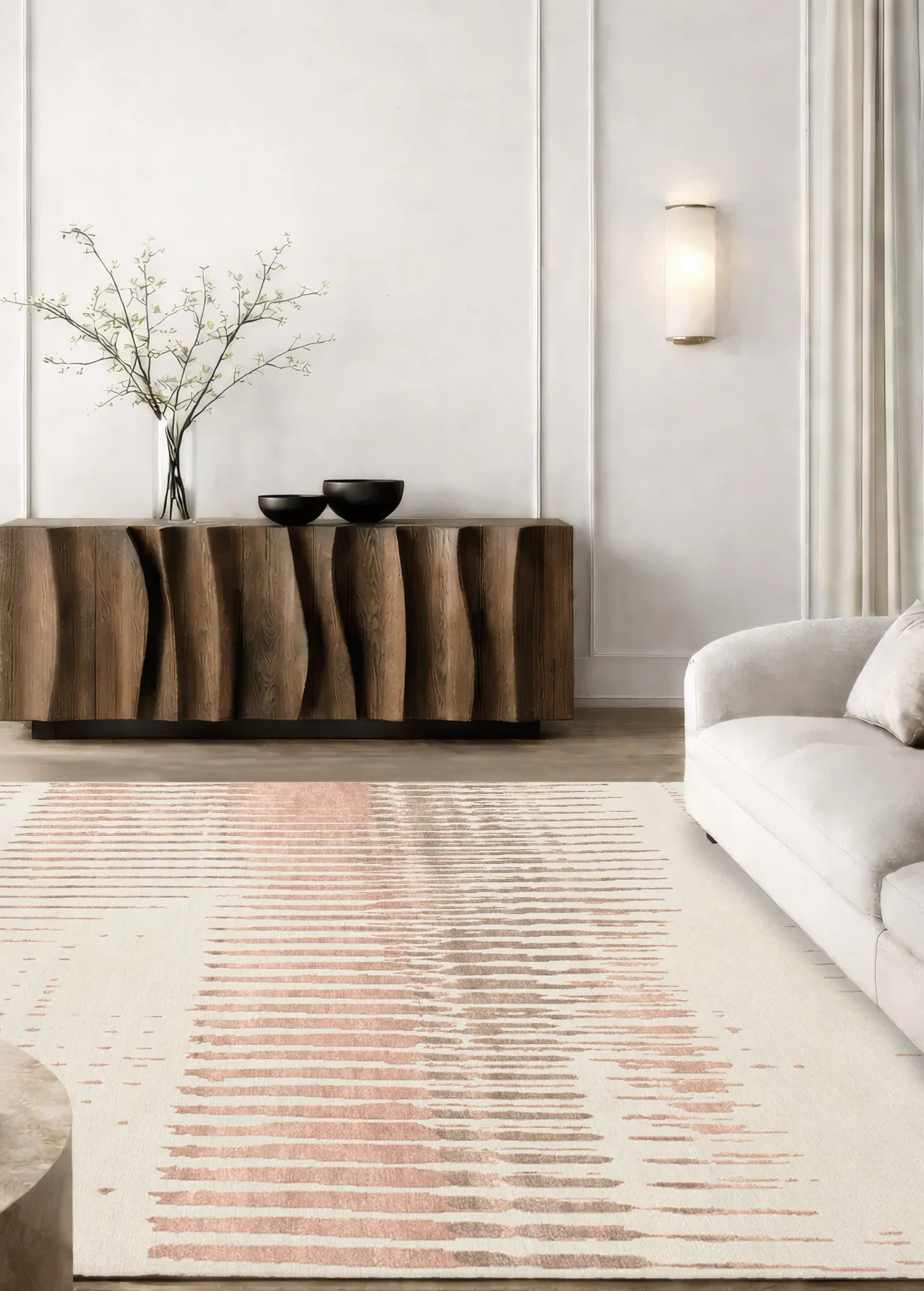 Luxury hand-knotted rug in ivory and terracotta tones with abstract linear pattern, styled in a contemporary interior with sculptural wooden sideboard and cream sofa, showcasing Northwest 35 craftsmanship.