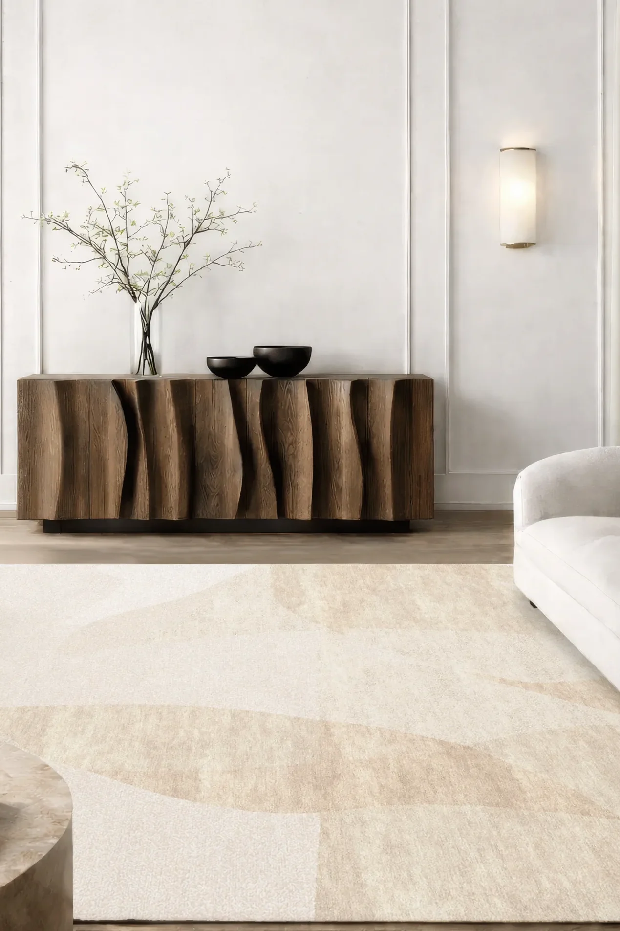 Hand-knotted luxury rug in soft peach shades with subtle tonal movement and layered texture, styled in a refined living space with sculptural wood sideboard, linen sofas and wall sconces, highlighting understated elegance and Northwest 35 craftsmanship.​