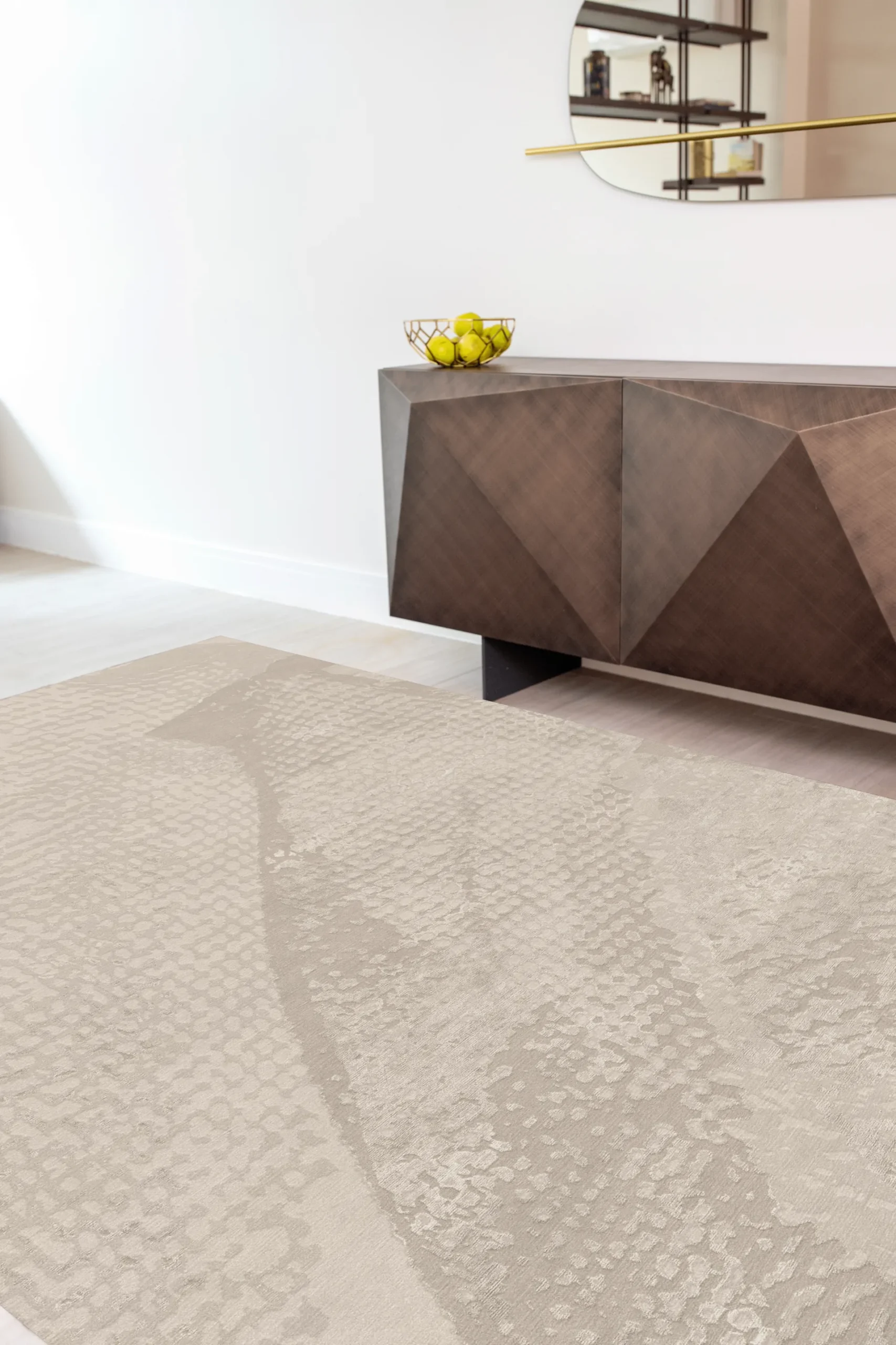 Luxury hand-knotted rug in sand colour with abstract textured pattern inspired by light and movement, styled in a contemporary interior with geometric wooden sideboard, showcasing Northwest 35 craftsmanship.​